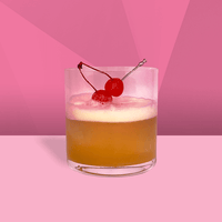 Amaretto Sour in short glass with cherry garnish